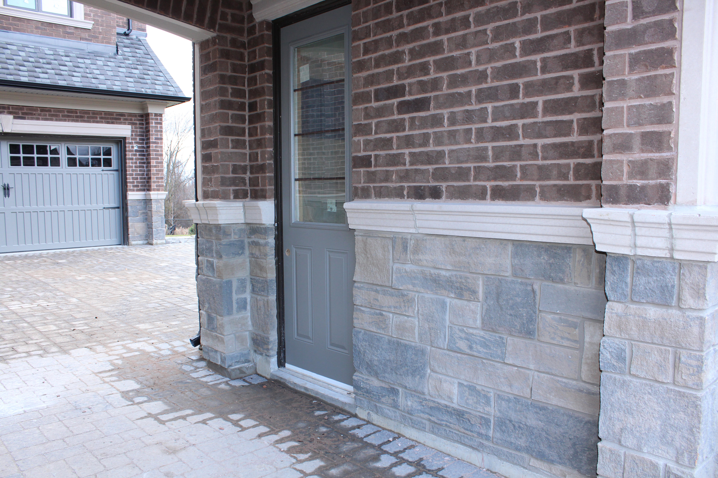 Princess Margaret Home garage shot and side door - Brick color is Westford, Stone color is Edgerock Delta Blend