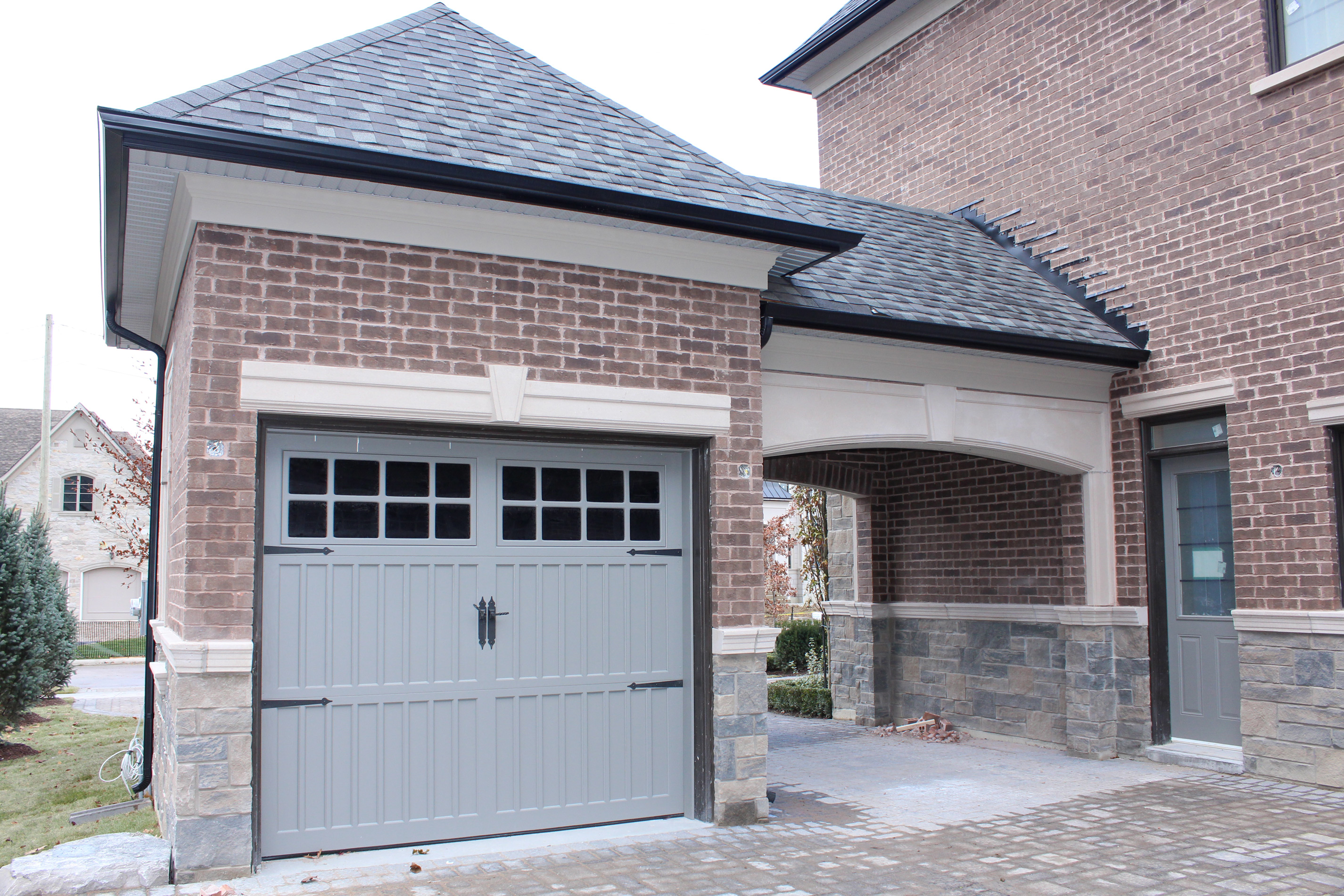 Princess Margaret Home garage shot and side door - Brick color is Westford, Stone color is Edgerock Delta Blend