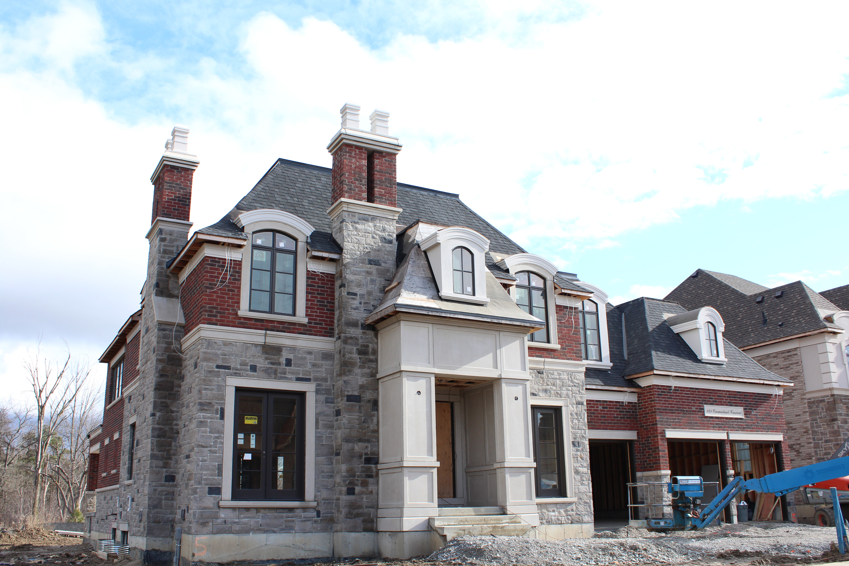 Front entrance shot of residential house. - Brick color is Wellington, Stone color is Chambord Grey with 5% Charcoal accent.
