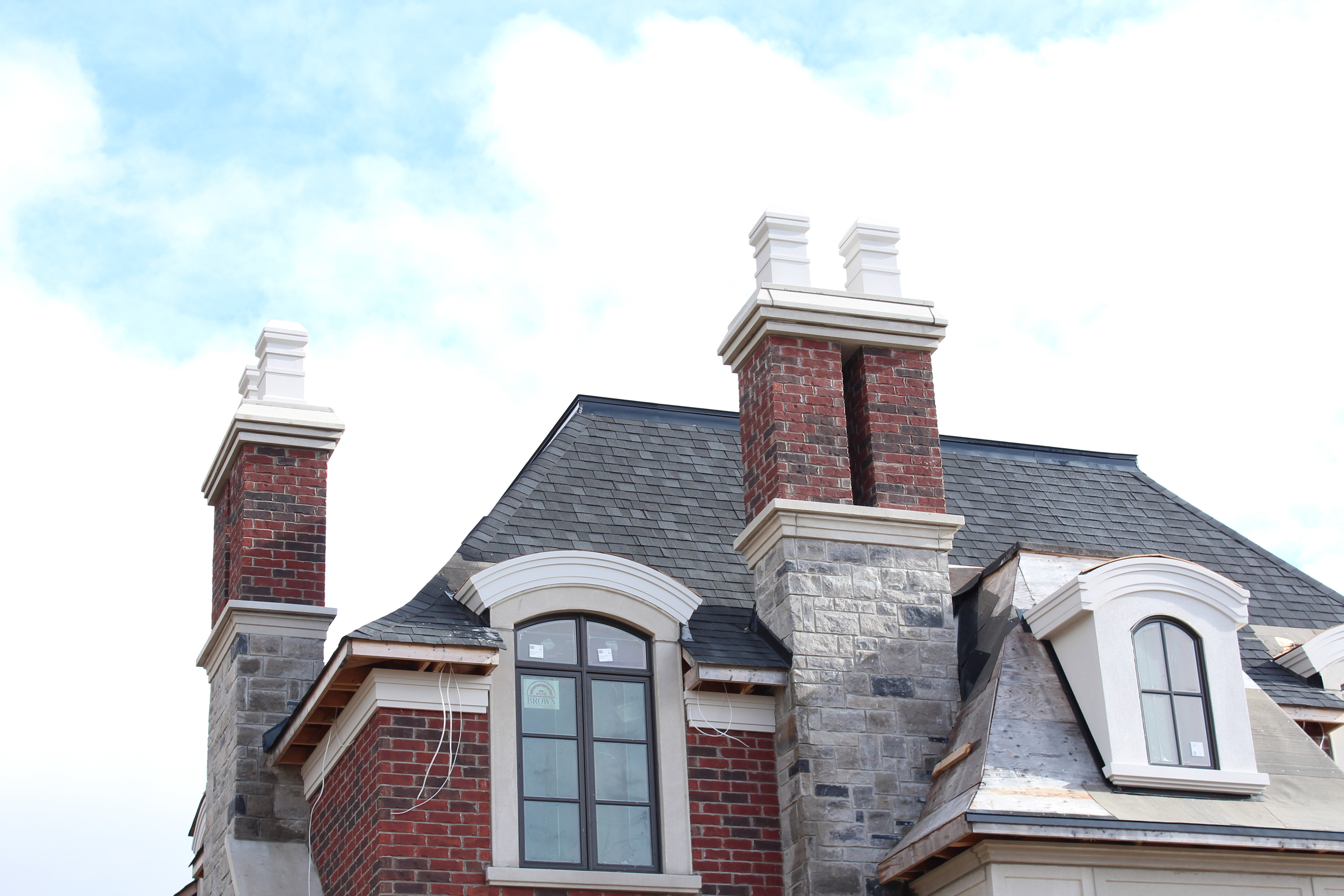 Roof shot of residential house. - Brick color is Wellington, Stone color is Chambord Grey with 5% Charcoal accent.