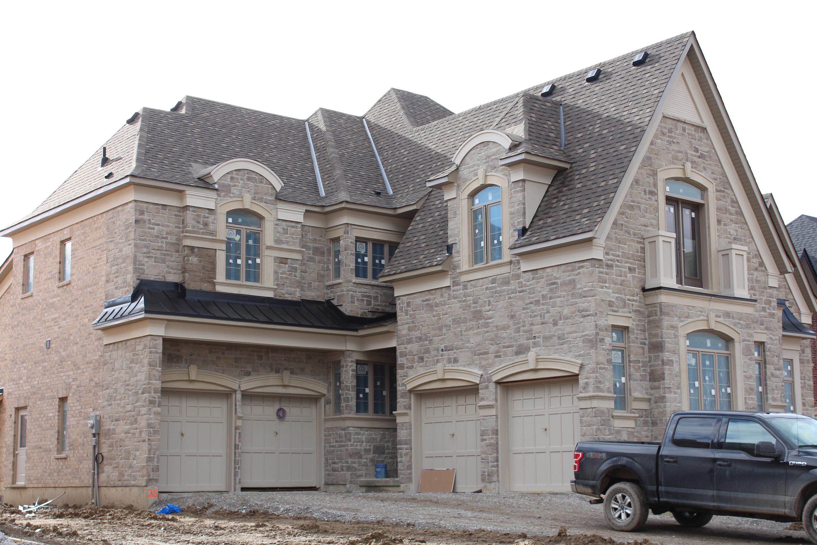 Wide shot of house with garage - Brick color is Cortes, Stone color is Margaux beige.