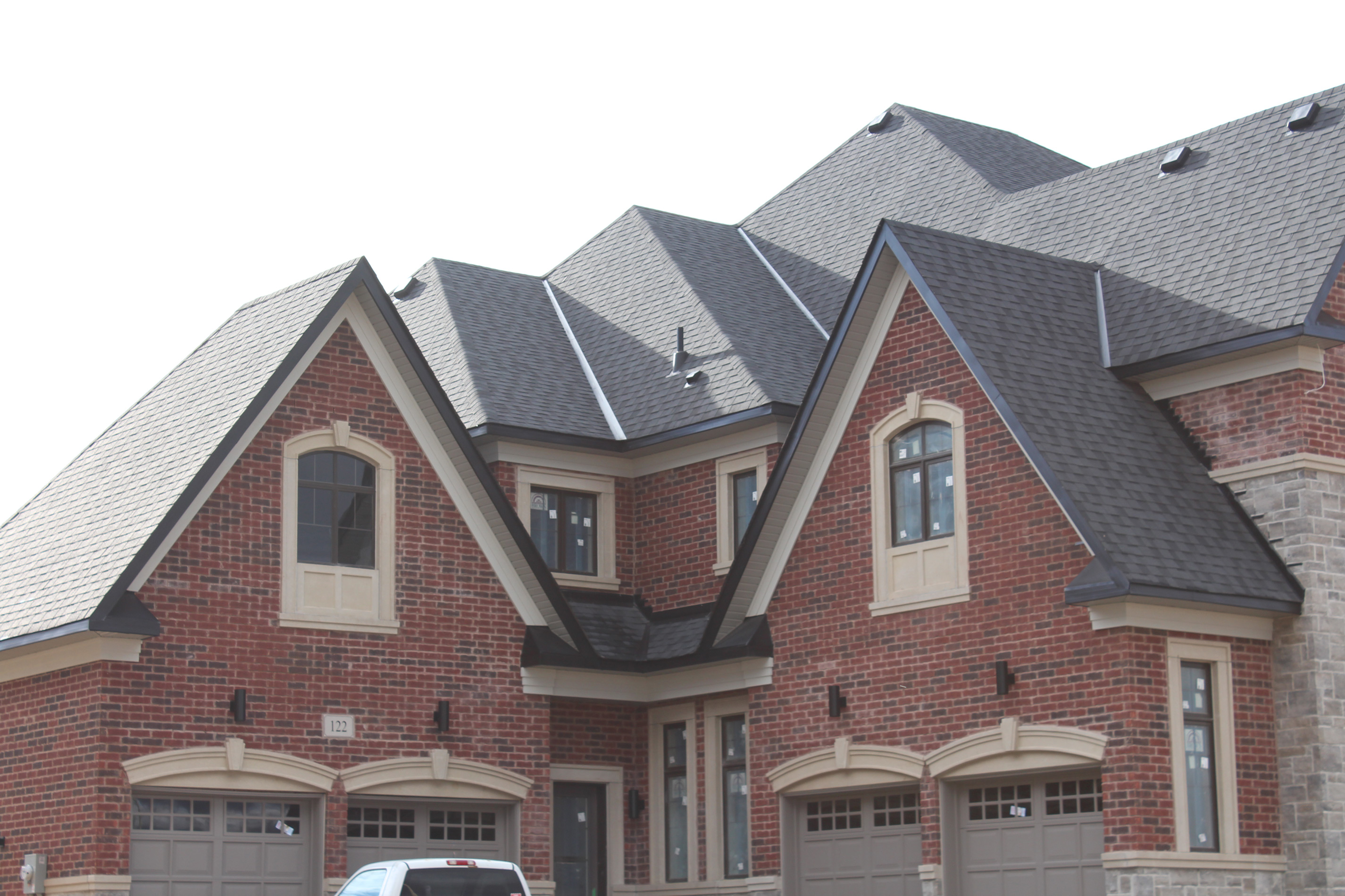 Roof shot of residential house. - Brick color is Wellington, Stone color is Chambord Grey.