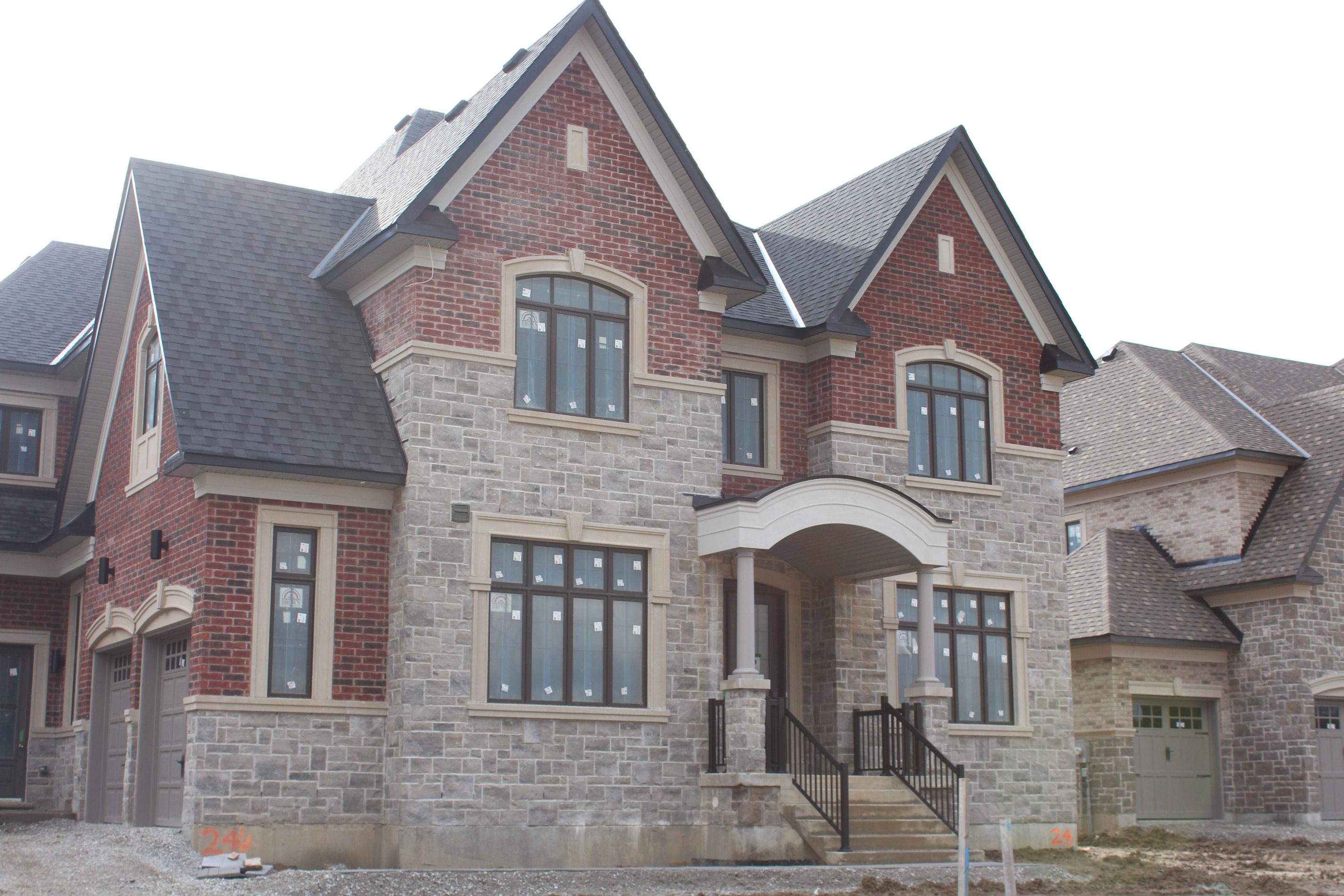 Wide shot of residential house. - Brick color is Wellington, Stone color is Chambord Grey.
