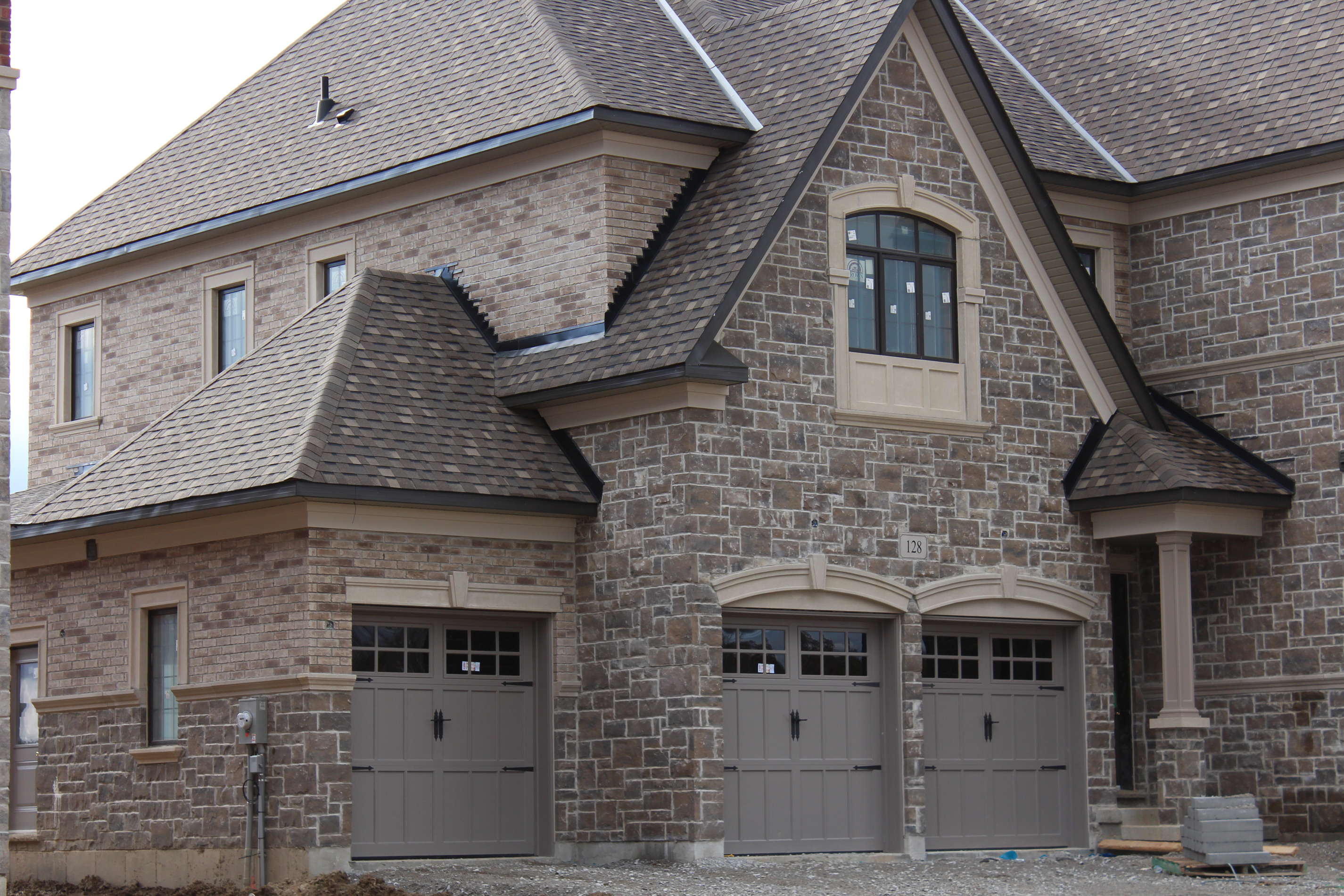 Wide shot of residential home and garage. - Brick color is Caldonia, Stone color is Berkeley brown.