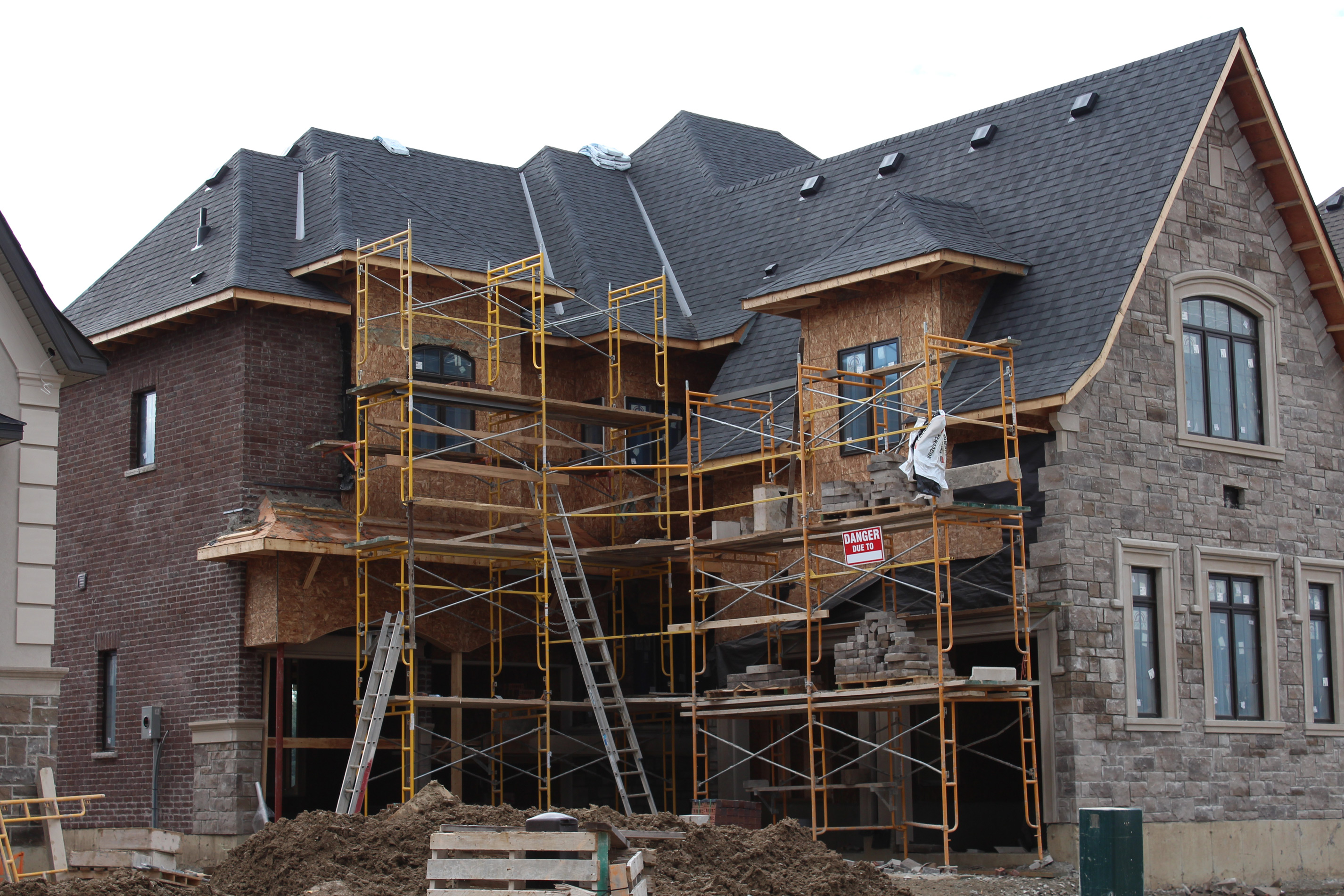 Wide shot of unfinished home. - Brick color is Battle Creek, Stone color is Chambord grey.
