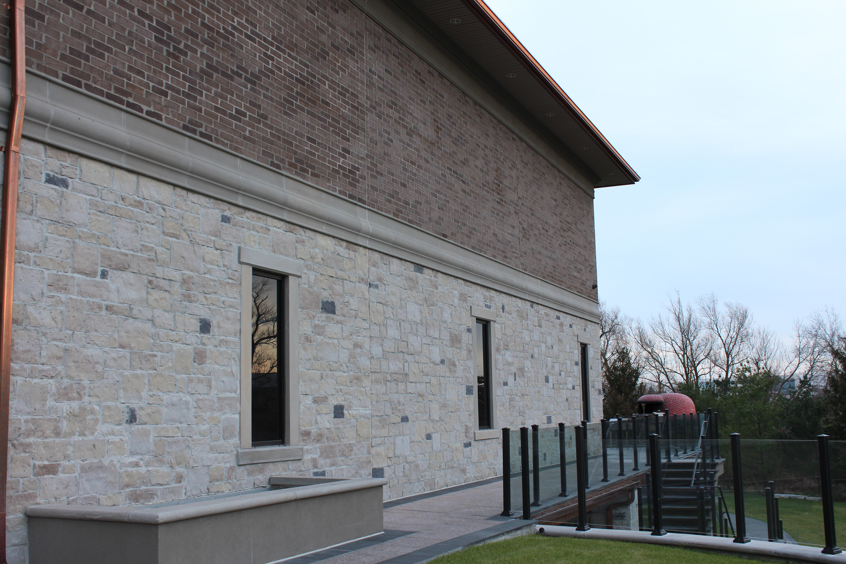 Side shot of building. - Stone colour is Vivace Milano, Brick colour is Sierra Brown